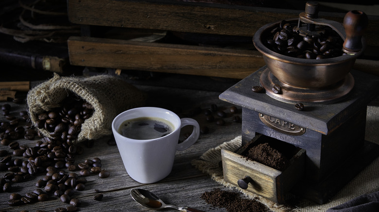 beans in vintage style coffee grinder