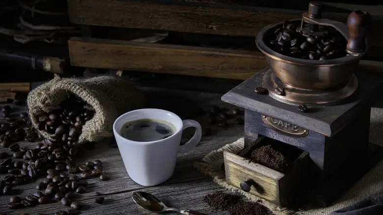 beans in vintage style coffee grinder